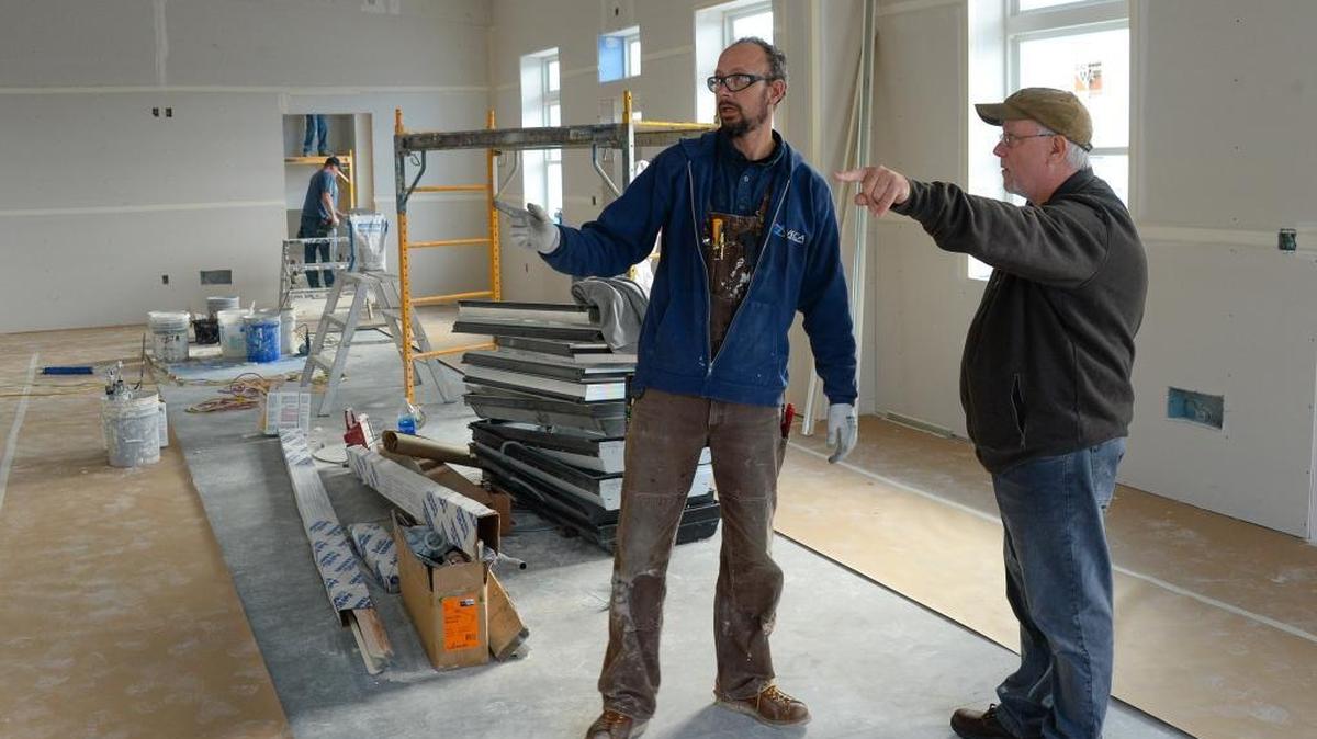 Veca Electric electrician Chris Meyer, left, and Bill Kimmerly, discuss construction details at the new location of Kimmerly's businesses Masquerade Wine Co., and Illuminati Brewing Co., on Hammer Drive in the Irongate area of Bellingham Thursday, Nov. 3, 2016.
