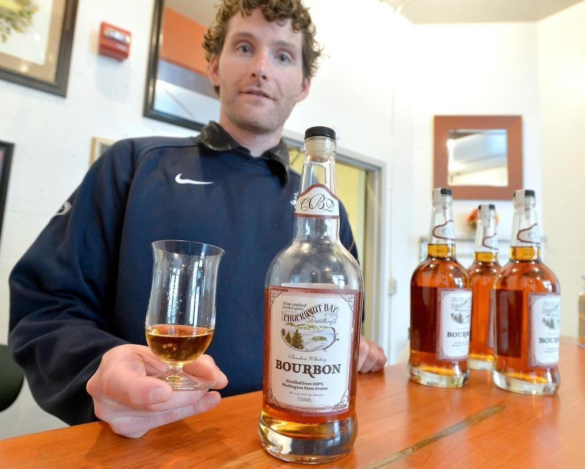 Co-owner and head distiller Matt Howell holds a glass of bourbon made at Chuckanut Bay Distillery in Bellingham. The distillery, located in the alley behind Rumors Cabaret at 1155 Railroad Ave., is open from 10 a.m. to 5 p.m. Monday through Saturday.