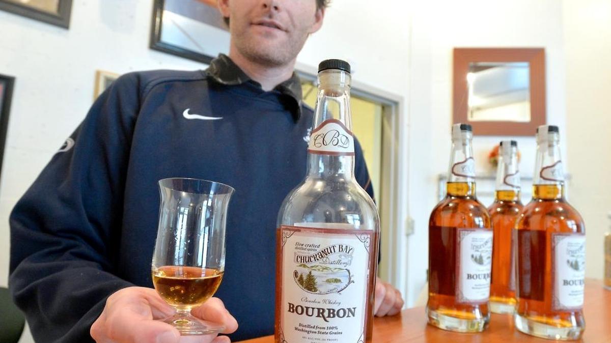 Co-owner and head distiller Matt Howell holds a glass of bourbon made at Chuckanut Bay Distillery in Bellingham. The distillery, located in the alley behind Rumors Cabaret at 1155 Railroad Ave., is open from 10 a.m. to 5 p.m. Monday through Saturday.