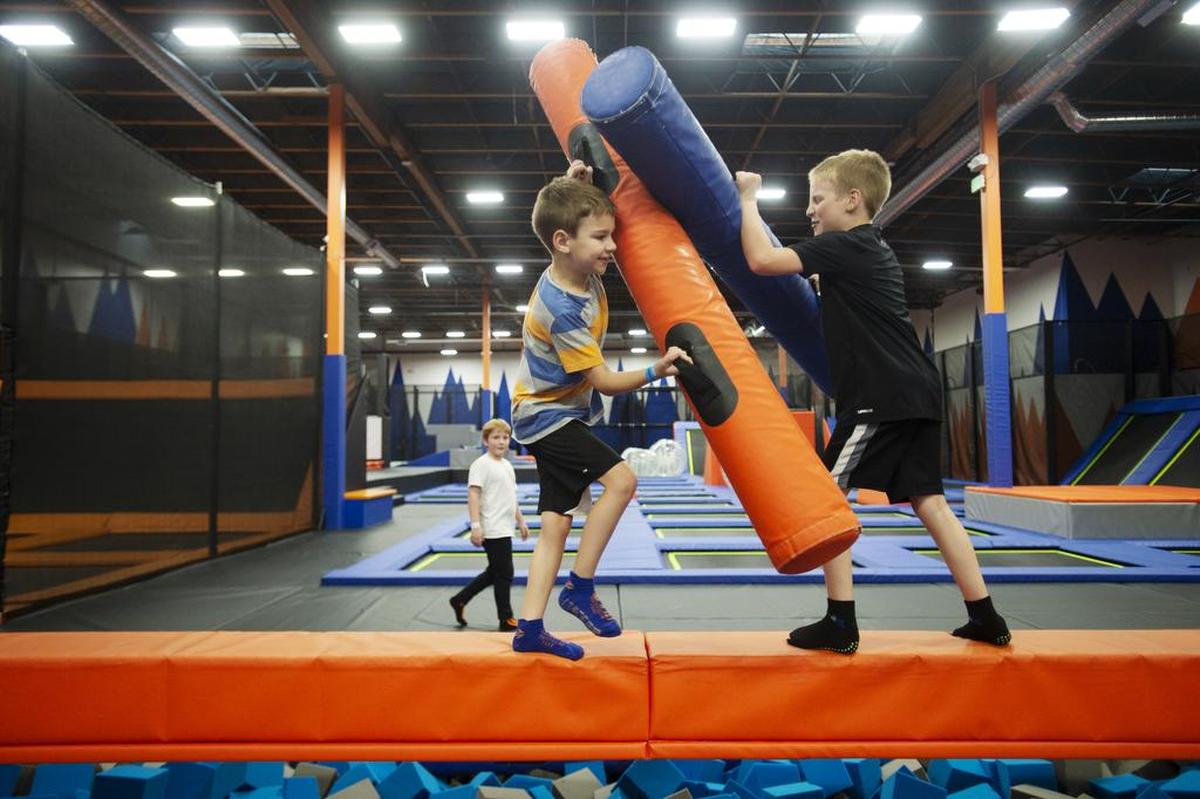 Isaac Dubrow, 7, and his brother Jacob Dubrow, 9, face off on the battle beam at Summit Trampoline Park in Bellingham. The pair comes to the park almost weekly.