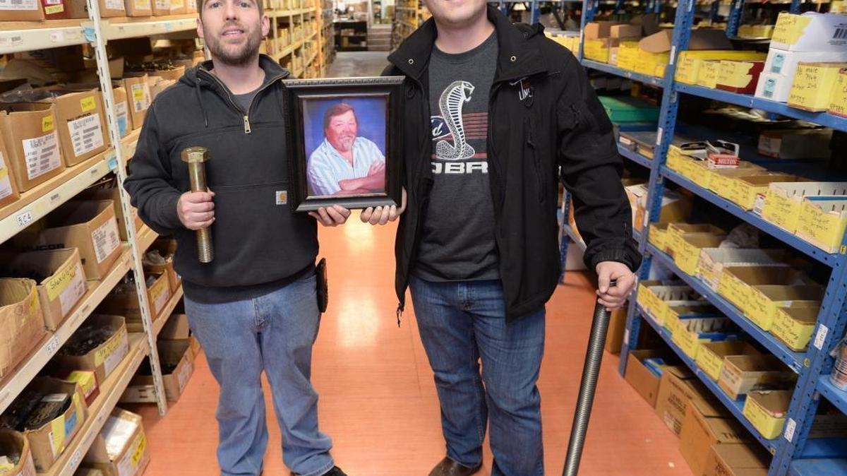 Brothers and co-owners Tim, left, and Jesse Clark hold a photo of their late stepfather, Robert LeCocq, in the retail location of their new business Lynden Bolt on Front Street in Lynden on Wednesday, Jan. 20. The retail store, which sells fasteners, electrical, chemical, safety and cutting tools, was the dream of Robert LeCocq.
