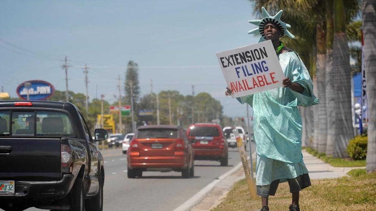 Delvin Evans advertises for Liberty Tax Services in Bradenton, Florida opn April 15, 2015. Liberty Tax Service is hosting a job fair and open house in Bellingham on Saturday, Dec. 16.