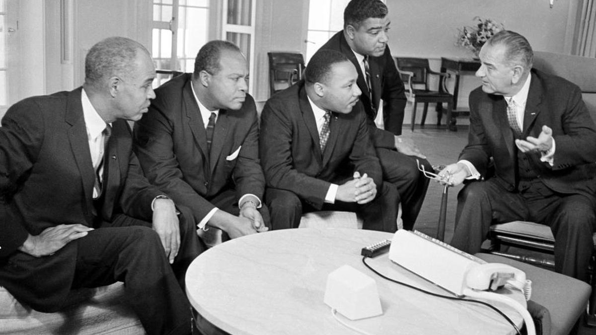 President Lyndon B. Johnson, right, talks with civil rights leaders, including Dr. Martin Luther King Jr., in his White House office in Washington, D.C., Jan. 18, 1964. The Civil Rights Act of 1968 provided much-needed protection for minorities and others when it comes to housing.