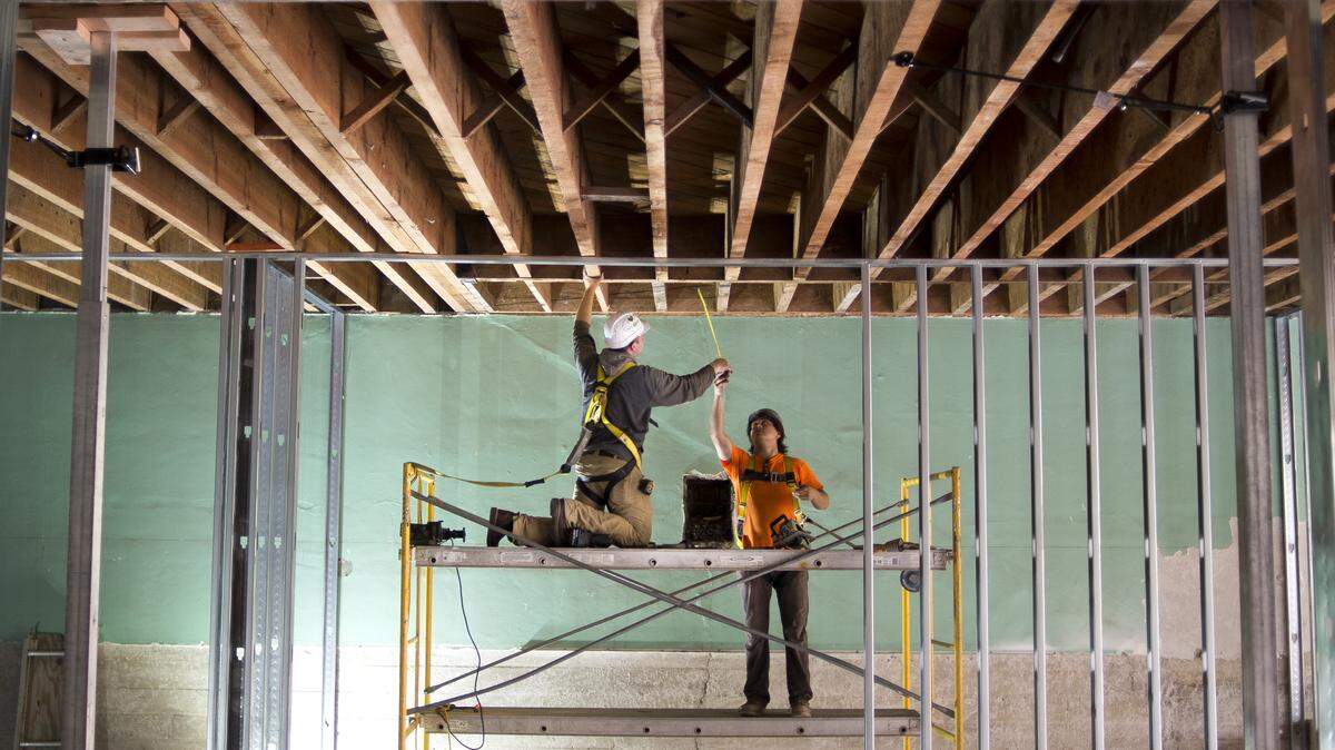 Zen Construction employees Sam Chue, right, and Eli Savage work on the future location of Chuckanut Distillery in downtown Bellingham.