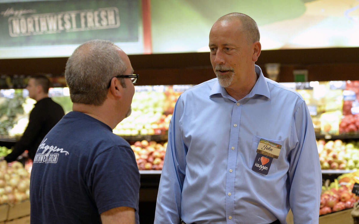 Haggen CEO John Clougher, right, talks with Haggen Barkley store manager Chris Sharick in Bellingham on Sept. 19, 2014, about one month after Clougher was hired. Haggen said Tuesday, Sept. 9, 2015 that the company has filed for Chapter 11 bankruptcy protection.