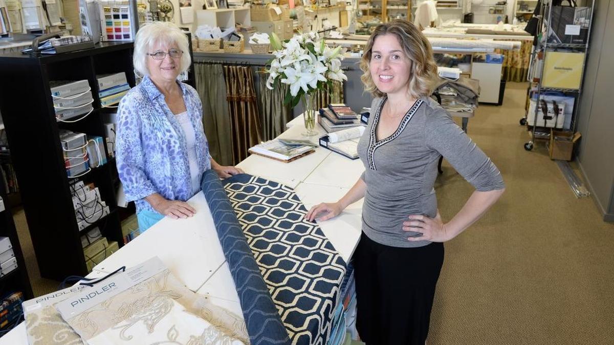Former owner of Lyn’s Draperies, Lyn Beatty, left, and new owner Jennifer Linds, at the Bellingham business, Tuesday, July 12, 2016.