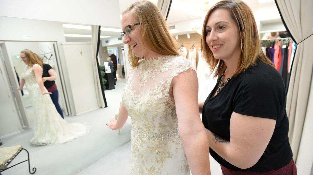 New owner Anna Lorenz helps Amanda Reese try on some wedding dresses at Belle Bridal in downtown Bellingham Thursday, May 26, 2016. Lorenz is also owner of the Glove & Gown bridal shop in Bellingham.