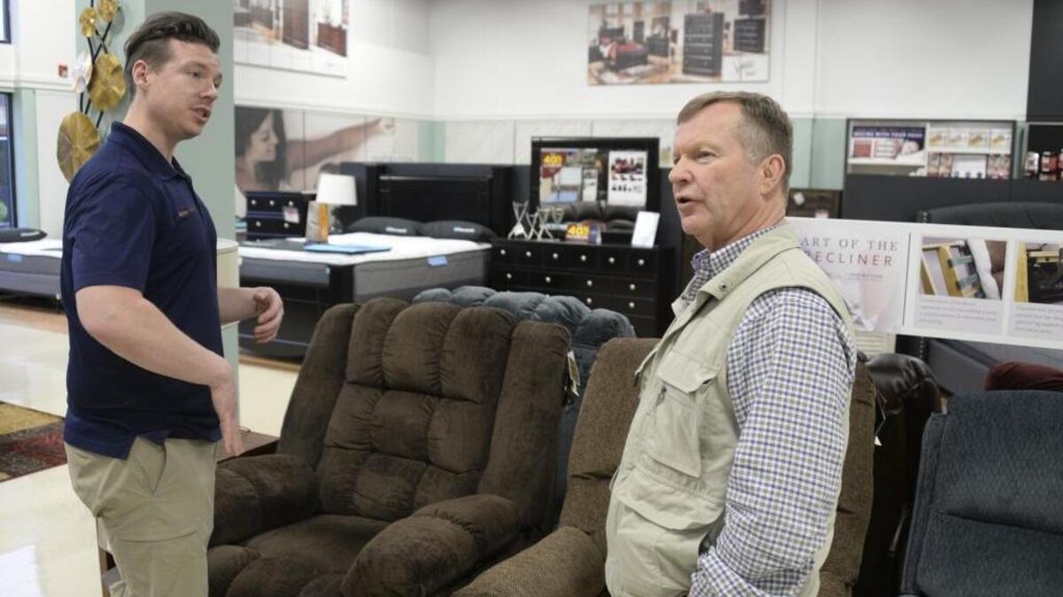 Store manager Clinton Branum shows customer Jim Grenz recliners at the Sears Hometown Store Tuesday, Jan. 17, 2017, in Bellingham.