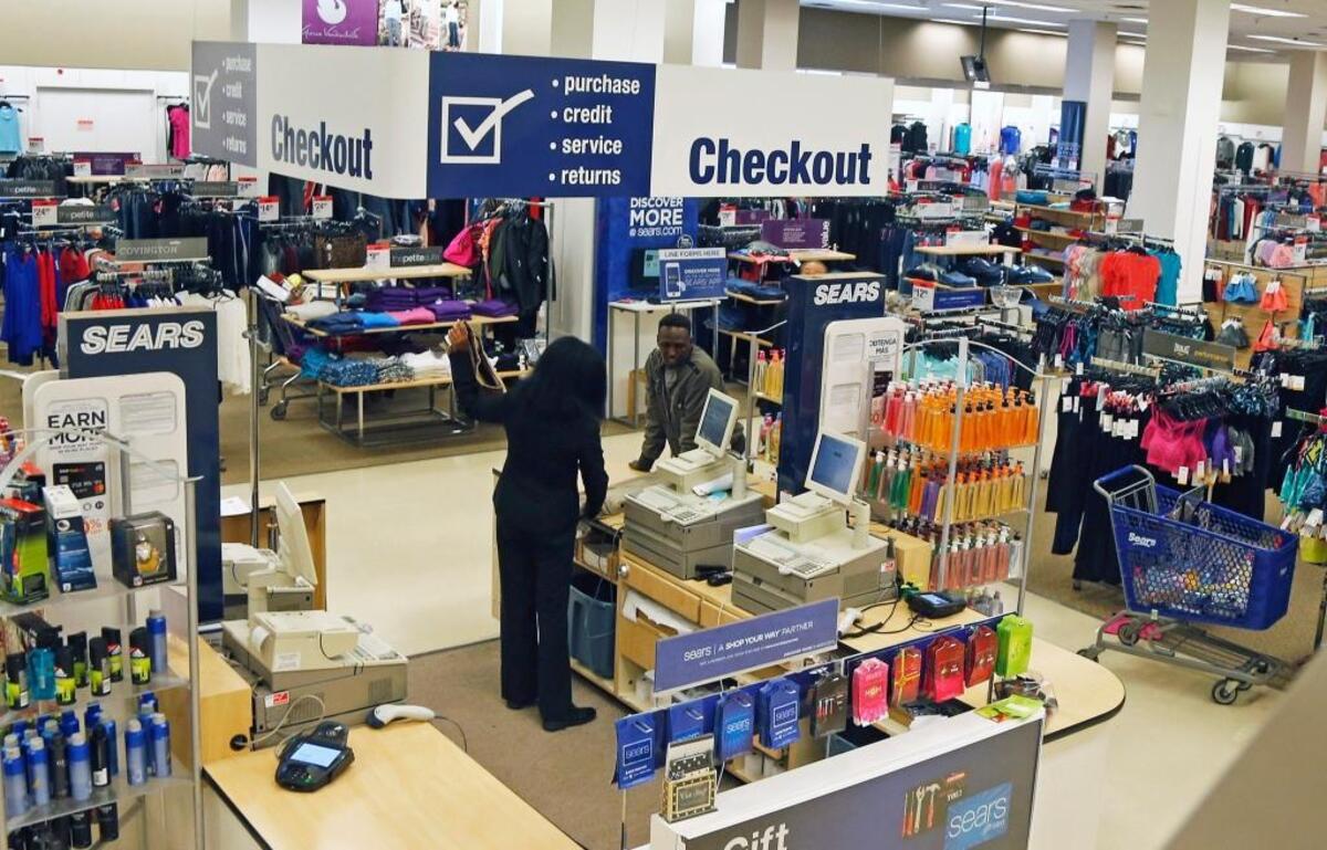 In this March 22, 2017, photo, a clerk waits on a customer at a Sears store in St. Paul, Minn.