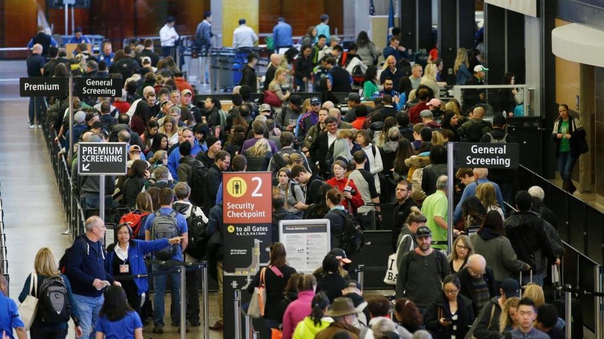 Travelers wait in line for security screening at Seattle-Tacoma International Airport in Seattle in March, 2016. Fliers will likely face massive security lines at airports across the country this summer, with airlines already warning passengers to arrive at least two hours early or risk missing their flight.