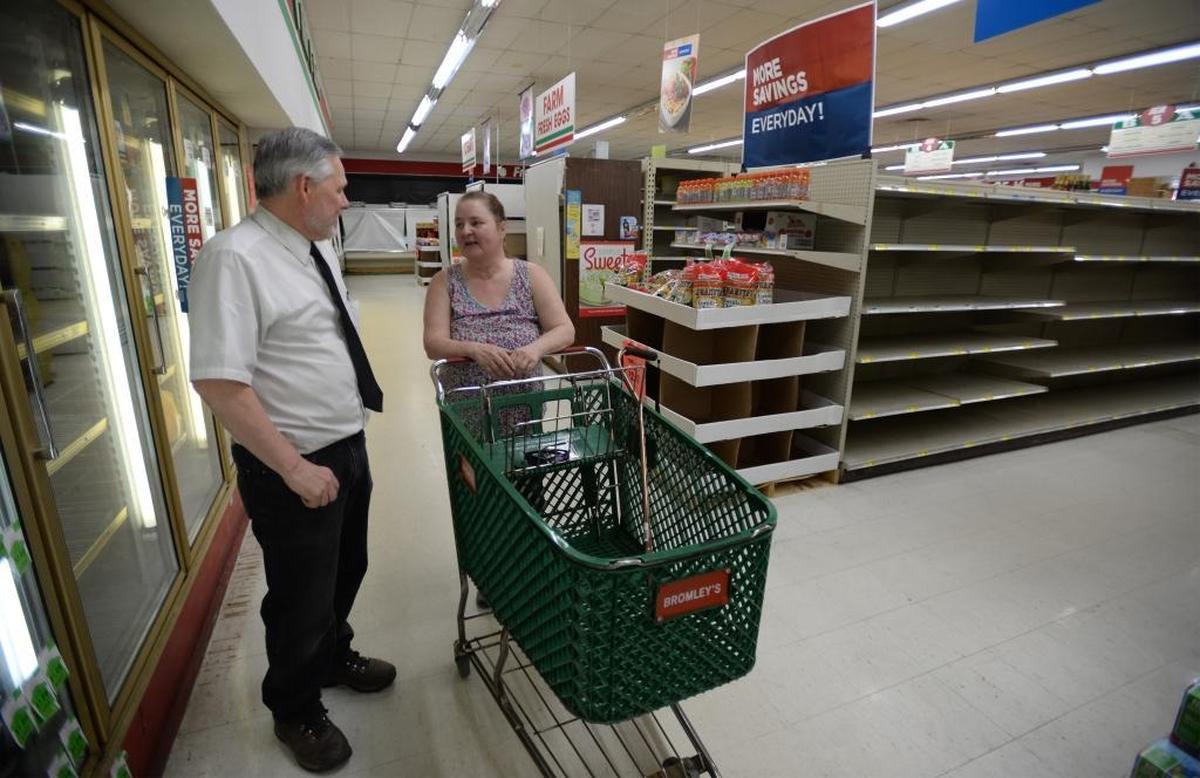 Store owner Bob Bromley talks to longtime customer Mary Cook at Bromley's Market in Sumas Monday, May 22, 2017. The grocery store, the only one in Sumas, will close Wednesday.The Bromleys have owned the market since 1960.