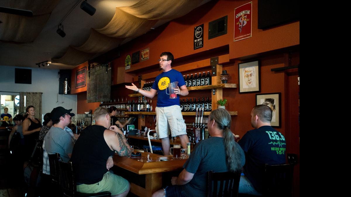 
Rob Whitney, manager at The Local Public House, draws tickets for raffle prizes at the Bellingham Beer Lab launch party on Wendesday, July 1, in Bellingham, Washington.
