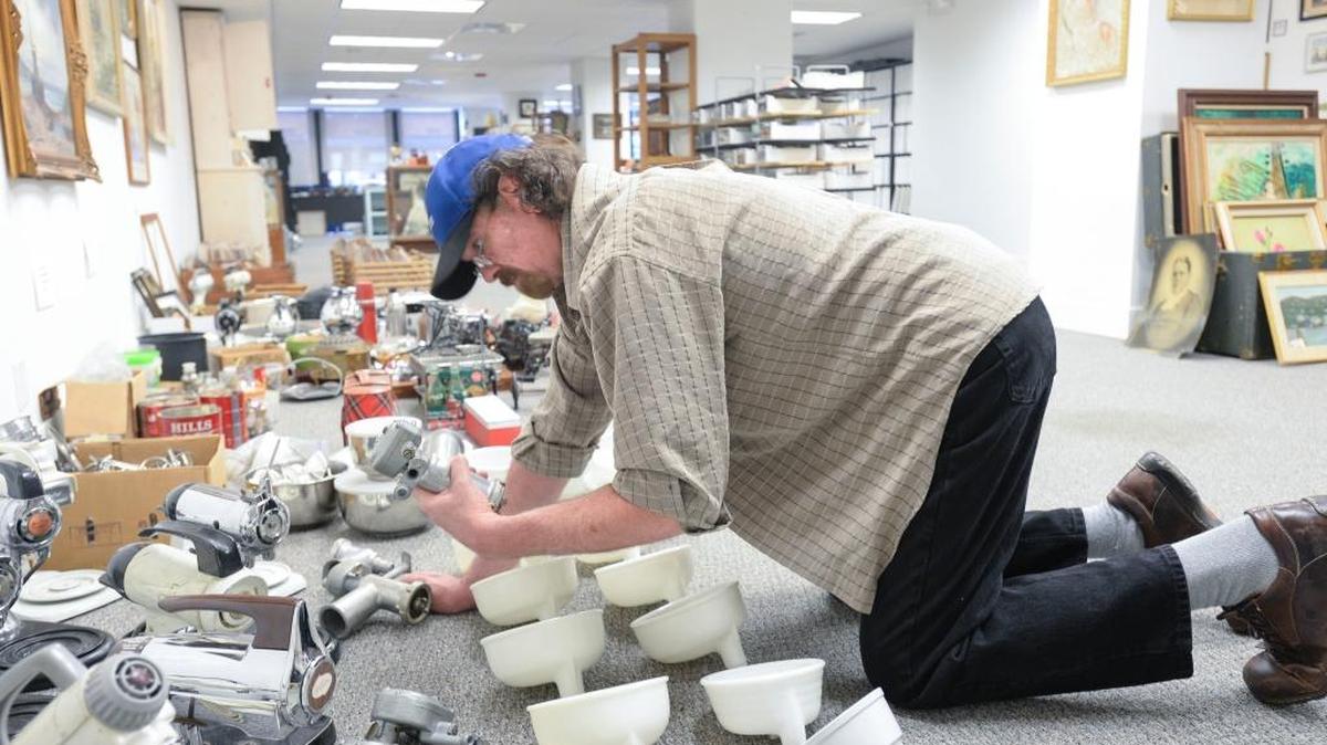 George Trummeter, owner of the antique store Vintage 360, looks at antique blenders for sale at The Stamp & Coin Place in downtown Bellingham on Wednesday, Jan. 13, 2016. The Stamp & Coin Place will have its last day of business on Holly Street on Thursday, Jan. 14, before moving to a warehouse where it will focus on online sales and by-appointment evaluations.