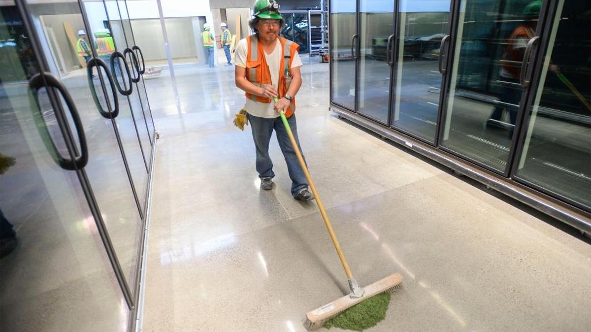 Abbott Construction’s Mike Ezukameow sweeps the floor between new coolers March 9, 2016, at the Whole Foods store going in at Lakeway Center in Bellingham. The store is scheduled to open in May.
