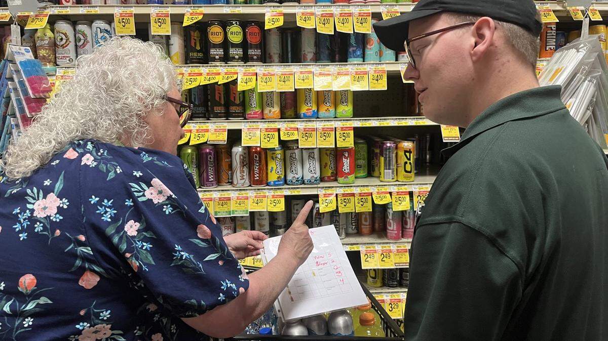 Job coach Feliecia Mulder helps student Kaden Taylor find the drinks he needs to restock shelves at Haggen in Bellingham. Taylor is a part of Bellingham’s Community Transitions program, which helps students in special education transition out of high school.