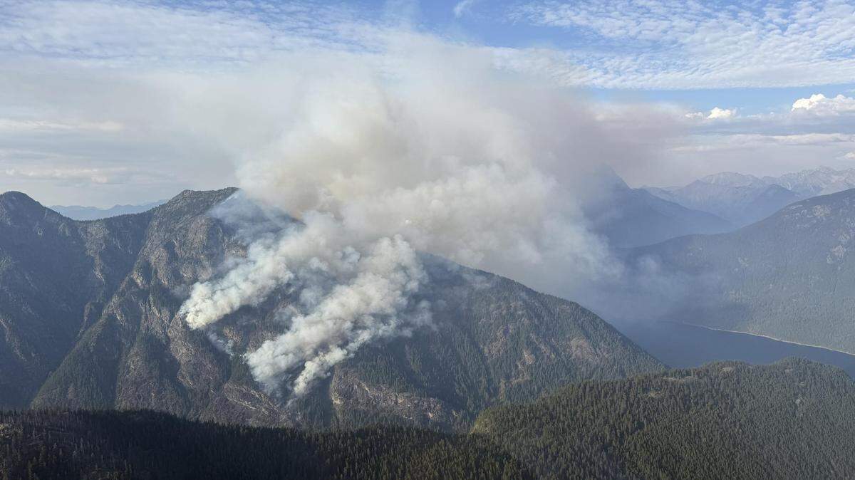 The cliff terrain is making it difficult for firefighters on foot to control the Perry Fire near Ross Lake.