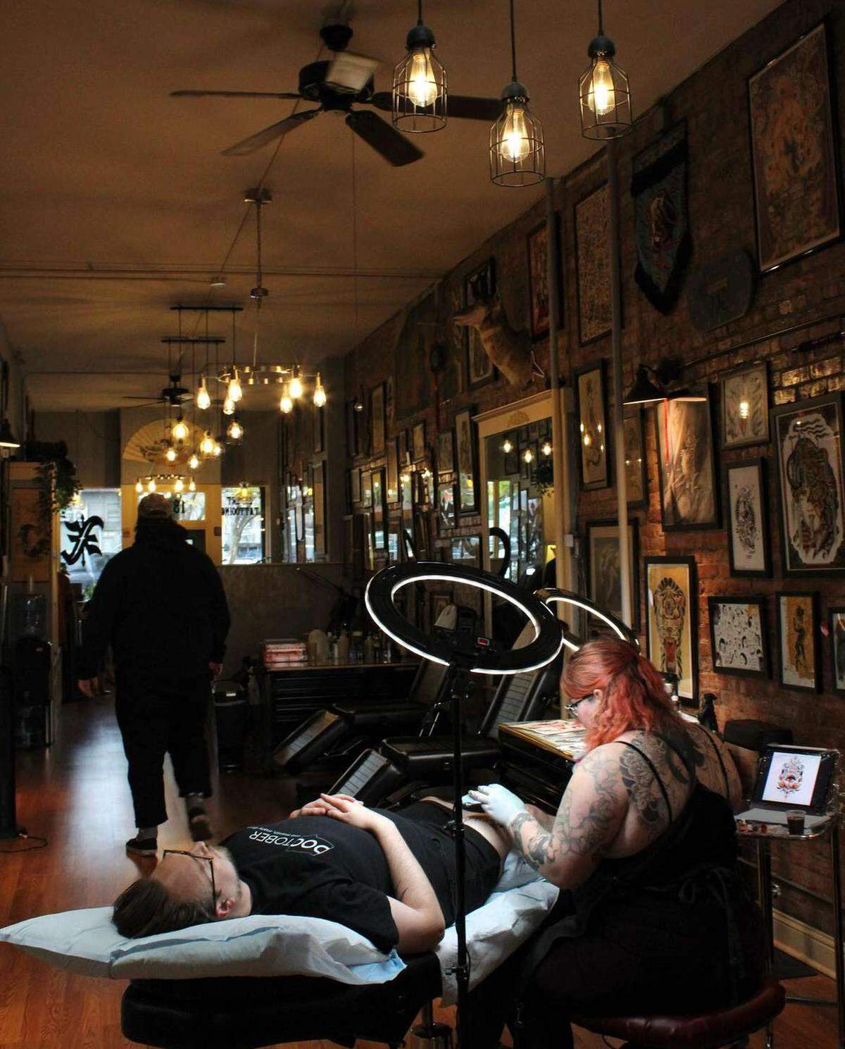 Beeker Wagner works on a customer’s tattoo at X Tattoo in Bellingham.