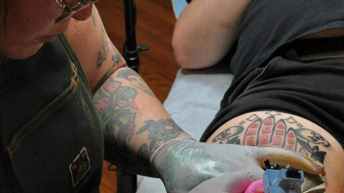 Beeker Wagner works on a tattoo for a customer at X. Tattoo in Bellingham.