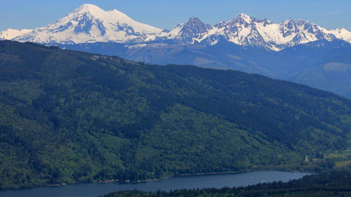 The Whatcom Land Trust is buying more than 1,000 acres of forest, including some old-growth trees, just at the base of the Twin Sisters range, right, above Lake Whatcom South Bay in this May 2017 photo.