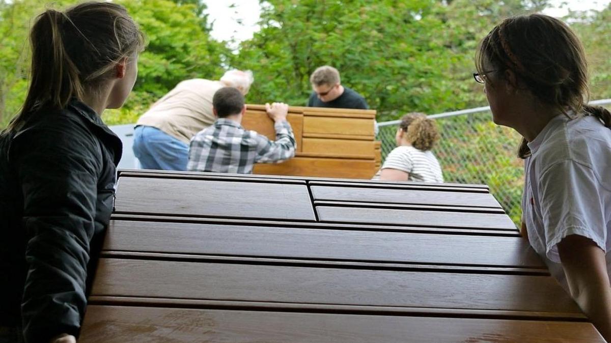 Volunteers move furniture as part of the House 2 Home program, which has been run through the Volunteer Center of Whatcom County. It and most other center programs are now part of the Opportunity Council.