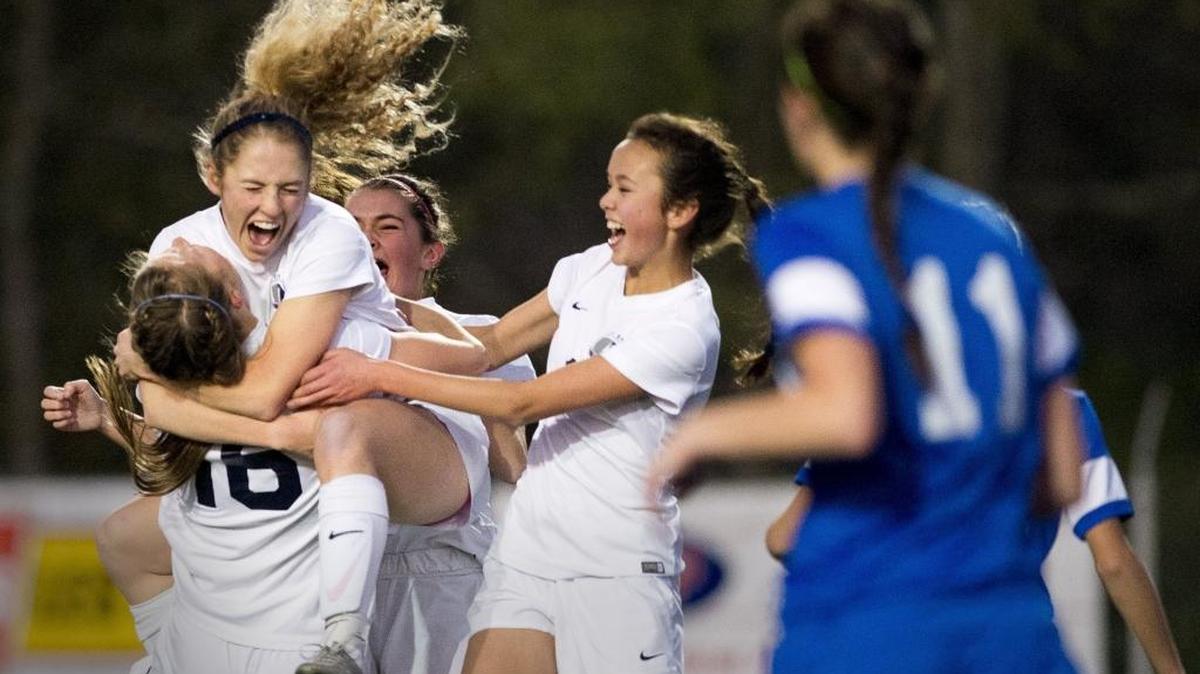 Squalicum’s Kim Hazlett jumps into the arms of Kim Dorr after scoring a goal during the WIAA 2A State Girls’ Soccer Tournament championship game on Nov. 21, 2015, in Shoreline, Wash. Members of the team are scheduled to appear at a Feb. 13 Bellingham event celebrating girls and women in sports.