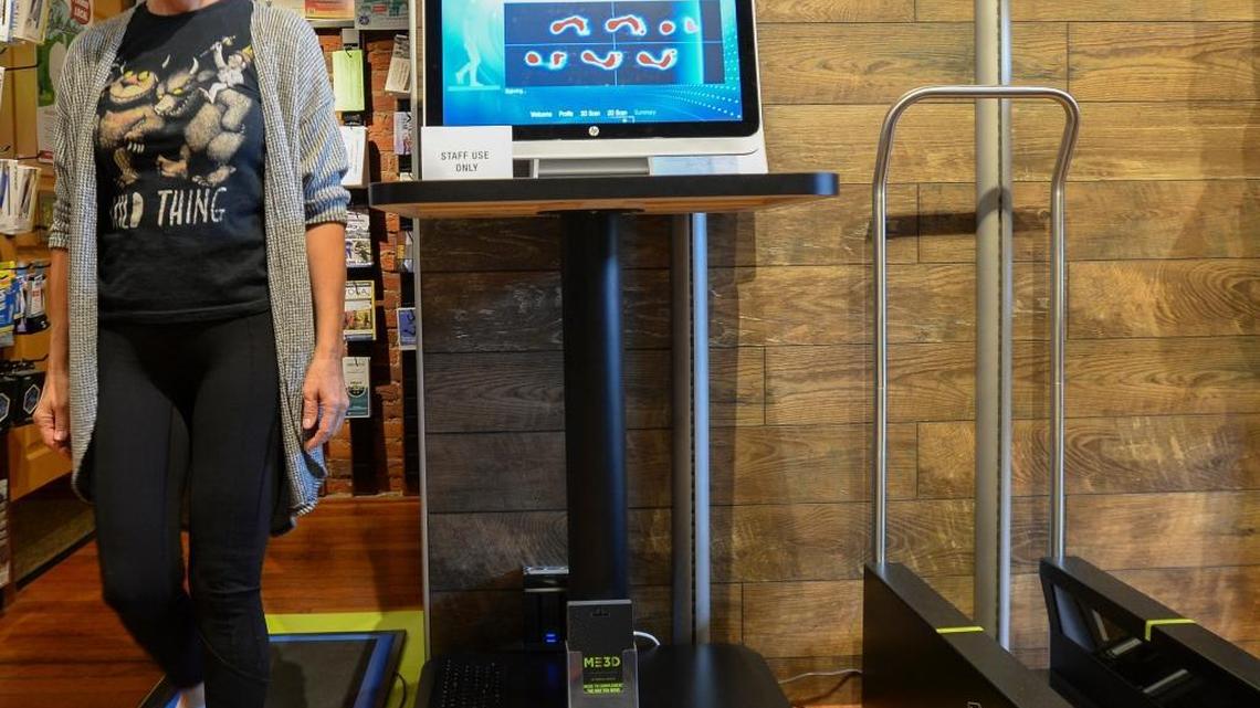 Customer Debbie Day walks on a pad that records her steps at the new Superfeet FitStation at Fairhaven Runners & Walkers in Bellingham, Thursday, July 27, 2017.