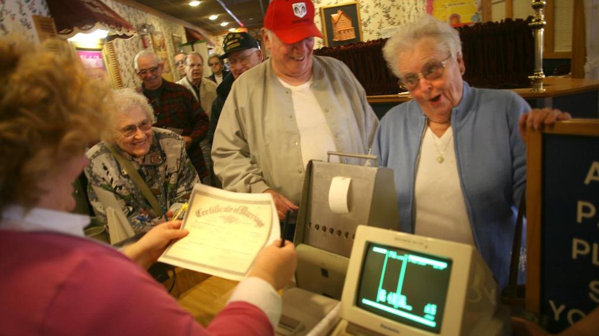 Lila Showalter, right, and her husband, Jack, get a few laughs over the authenticity of their marriage certificate with General Manager Lilian Roach at the Old Country Buffet in Kennewick in 2007. The restaurant chain has struggled with bankruptcy, however, which led to the June 14, 2016, closure of its Bellis Fair location.