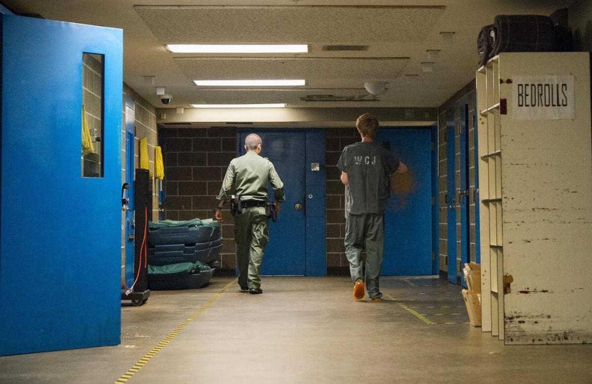 A deputy escorts an inmate to a minimum security housing area July 4, 2015, at Whatcom County Jail in Bellingham, Wash.
