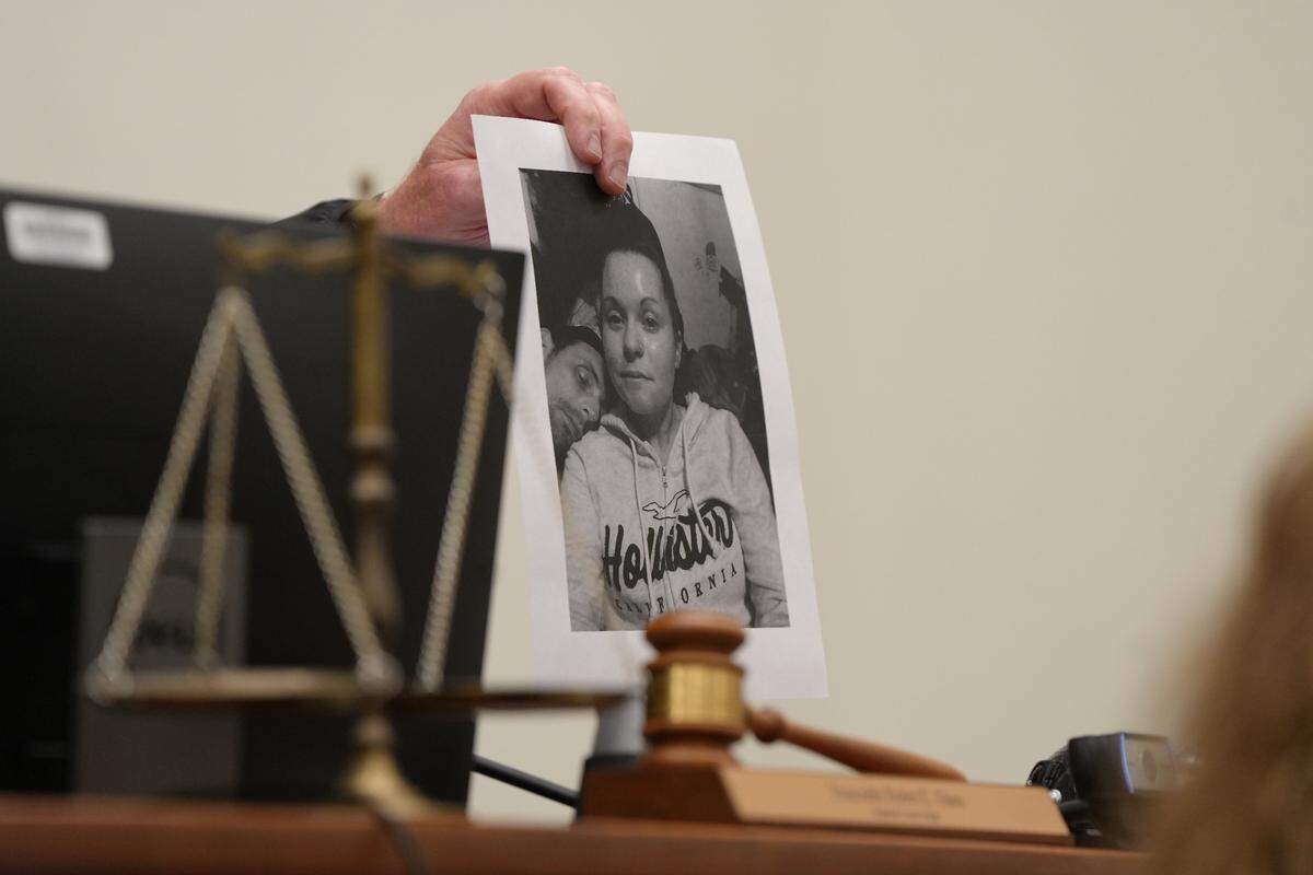 Whatcom County Superior Court Judge Rob Olson holds up a photo during a sentencing hearing on July 1, 2024, of Kasaundra “Kassy” May Booker, who was fatally shot by Shilo Aron Englert, 35, on Feb. 8, 2022, in Bellingham, Wash.