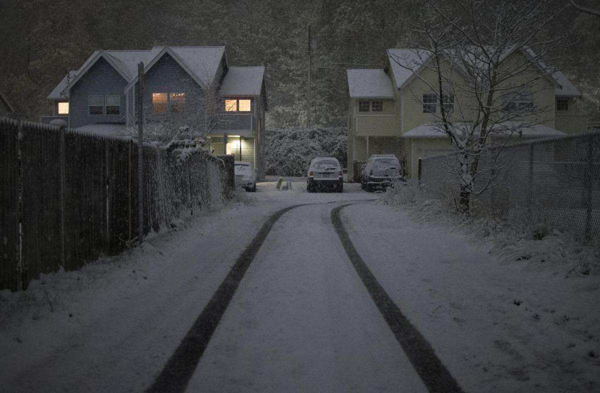 Snow blankets houses near Whatcom Falls Park late Thursday night, Nov. 2, in Bellingham, Washington.