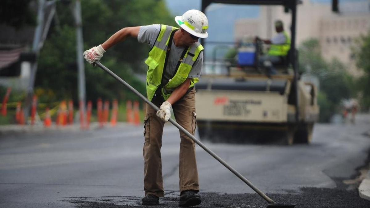 Jeff McClintock from Granite Construction rakes asphalt during the repaving of Dupont Street in Bellingham July 17, 2012. Several county roads south of Sumas will be repaved the week of April 18, 2016, causing delays; drivers should use other routes.