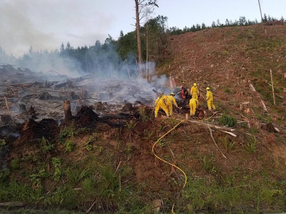 Fire crews dig a line to contain the fire Monday morning.