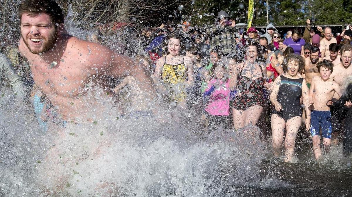 Hundreds of people jump into Lake Padden at the 2014 Padden Polar Dip on Jan. 1 in Bellingham, Wash.