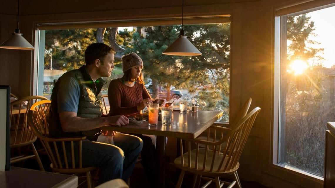 Brett Nelson, left, and Melissa Bahr dine at Cliff House during sunset on Tuesday, Dec. 20, 2016, in Bellingham.