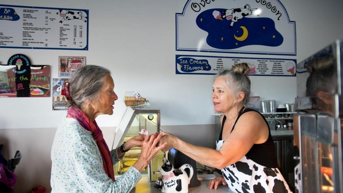 Over The Mooon owner Elizabeth Owens, right, hands an ice cream sample to Shira Nahari on Thursday, June 23, in Everson. Nahari, an Everson resident who was making her second visit to the shop, said, “I broke my three-year ice cream sugar fast here.”