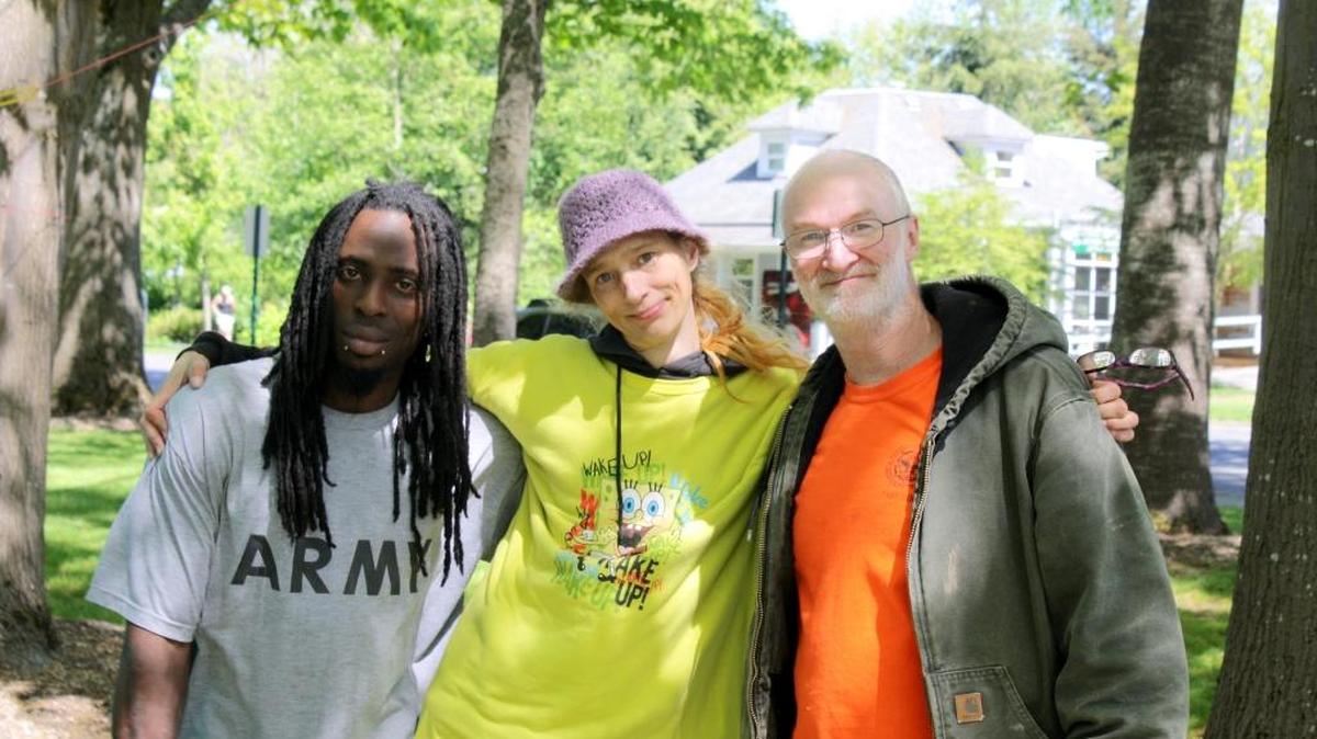 Atiba Fleming, left, Laura Rawes, and Dane Loewen pose for a photo outside Bellingham City Hall. Rawes, who was homeless until she got a place in supportive housing in 2015, gathered a group of homeless people who camped on the lawn May 1 and 2 to call for housing and shelter.