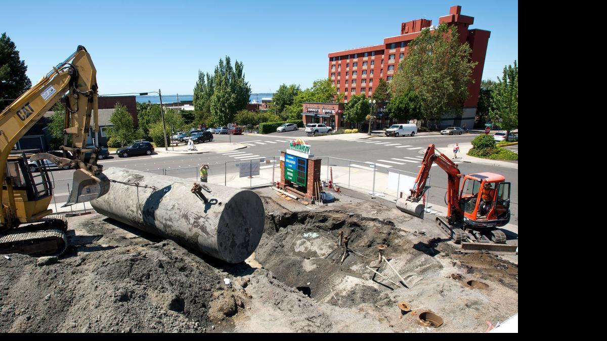 
Construction workers pull fueling tanks out of the ground at Yorky's Market in the Fairhaven neighborhood on Tuesday, June 9, in Bellingham, Wash. The visible tank is one of four to be removed.
