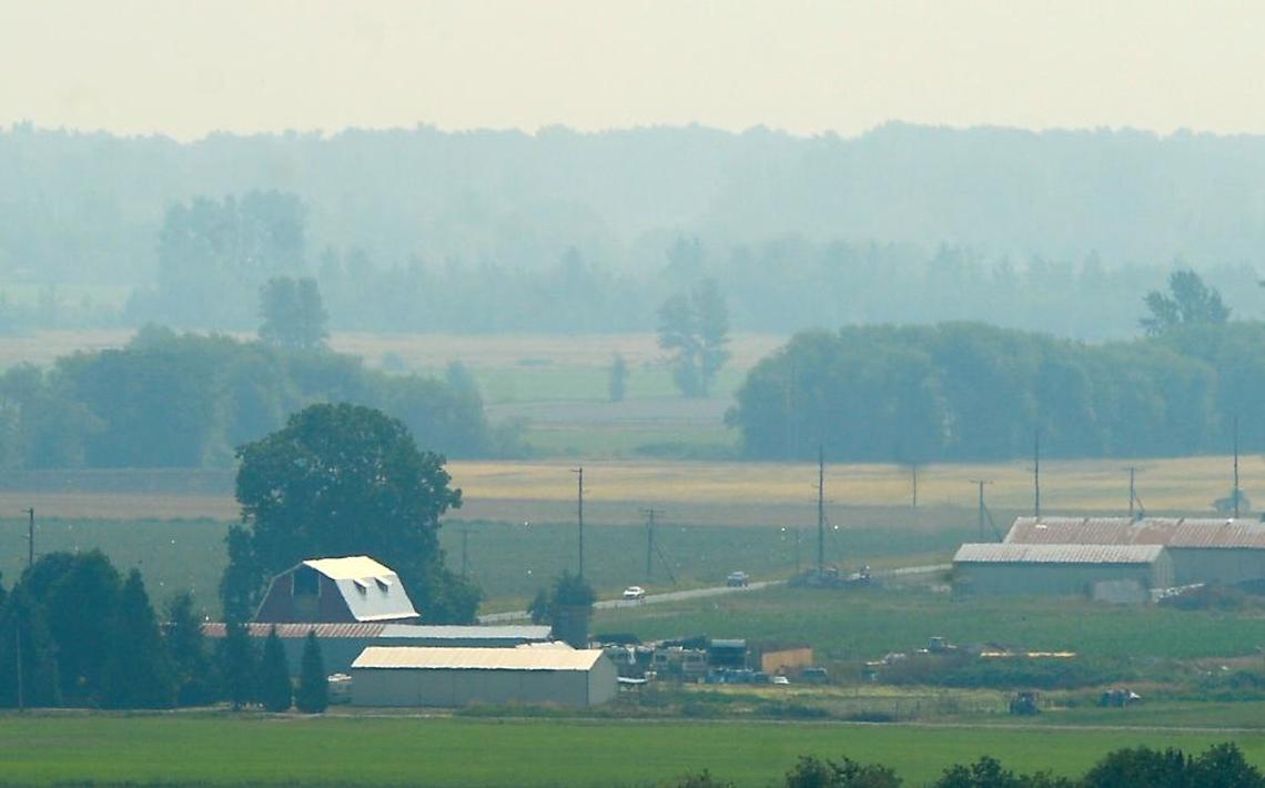 Smoke from forest fires in British Columbia continues to cover farmland south of Ferndale in haze Thursday, Aug. 10, 2017. Smoke should begin clearing by midday Friday, according to the National Weather Service.