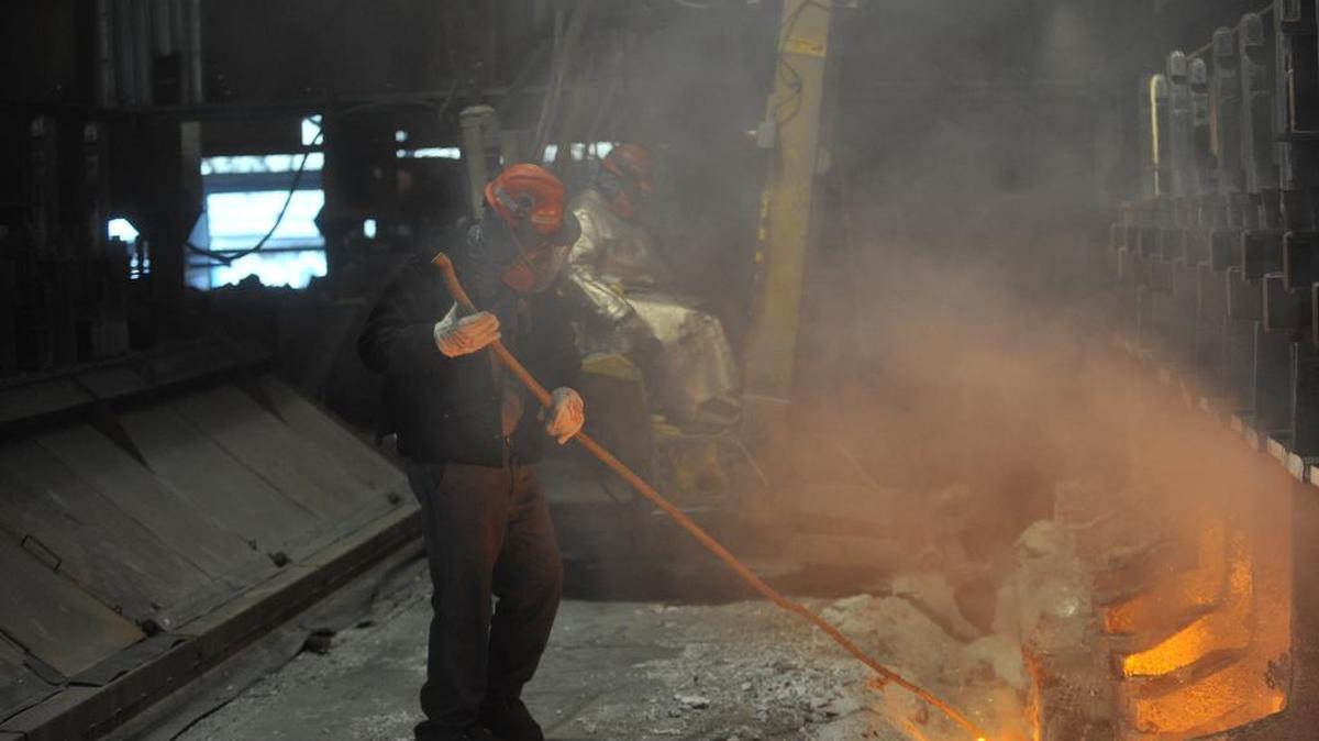 Workers tend aluminum smelter pots on potline B at the Alcoa Intalco aluminum smelter west of Ferndale, on Feb. 15, 2011. Intalco will chutter most operations next year, laying off 465 workers.