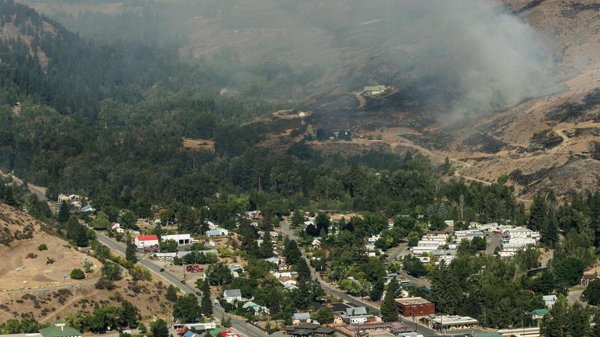 
In this aerial photo, a wildfire moves closer to homes in Twisp, Wash., on Thursday, Aug. 20, 2015. Firefighters on several fronts are fighting against raging wildfires advancing on towns in the north-central part of the state. 

