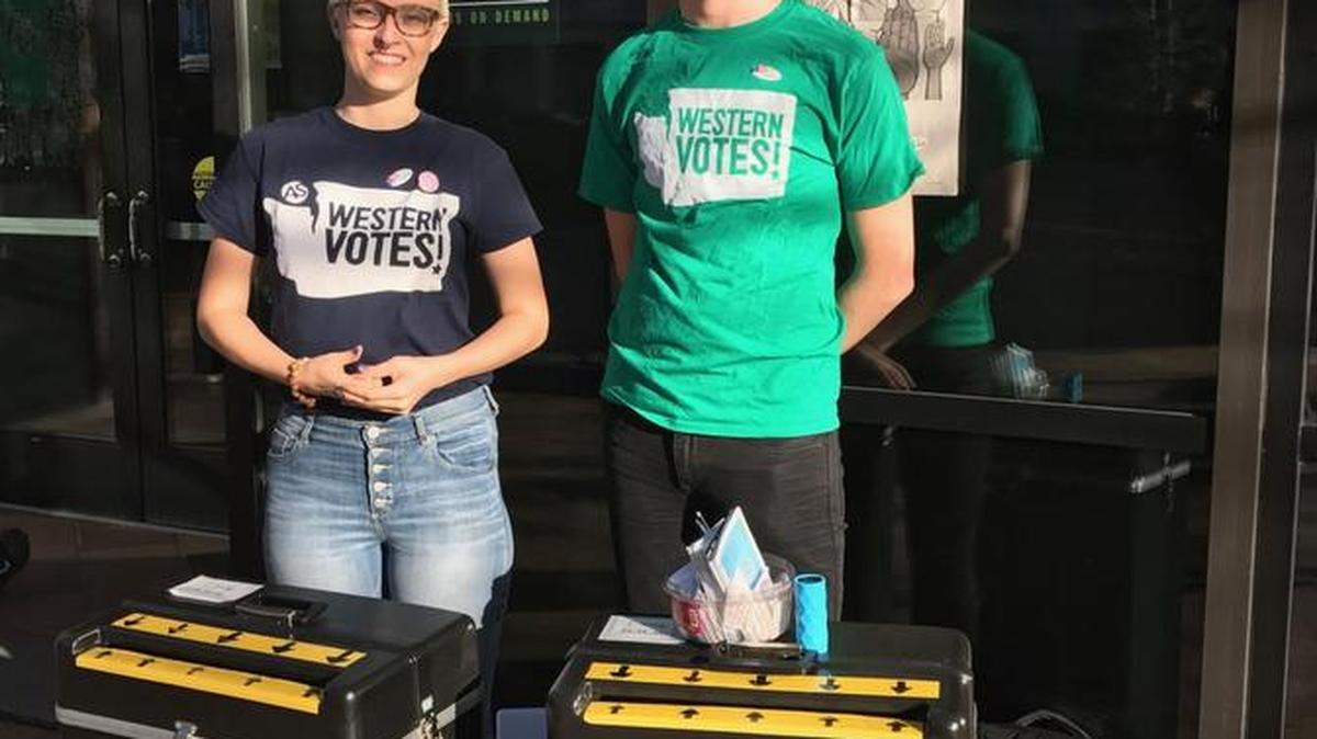 Volunteers Josie Ellison, left, and Henry Pollet, staff two additional ballot drop boxes on Western Washington University’s campus Tuesday, Nov. 8, 2016. The two were sworn in by the Whatcom County Auditor’s Office, and the boxes were sealed by the auditor’s office, and will be collected at the end of the day. The boxes were in front of Arntzen Hall Tuesday morning, and then moved to the Viking Union.