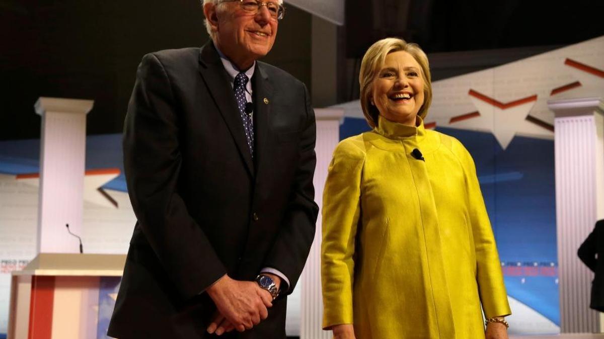 Democratic presidential candidates Bernie Sanders and Hillary Clinton smile as they take the stage before a Democratic presidential primary debate at the University of Wisconsin-Milwaukee, in Milwaukee on Feb. 11. Democrats in Washington state will pick their presidential nominee Saturday, March 26.