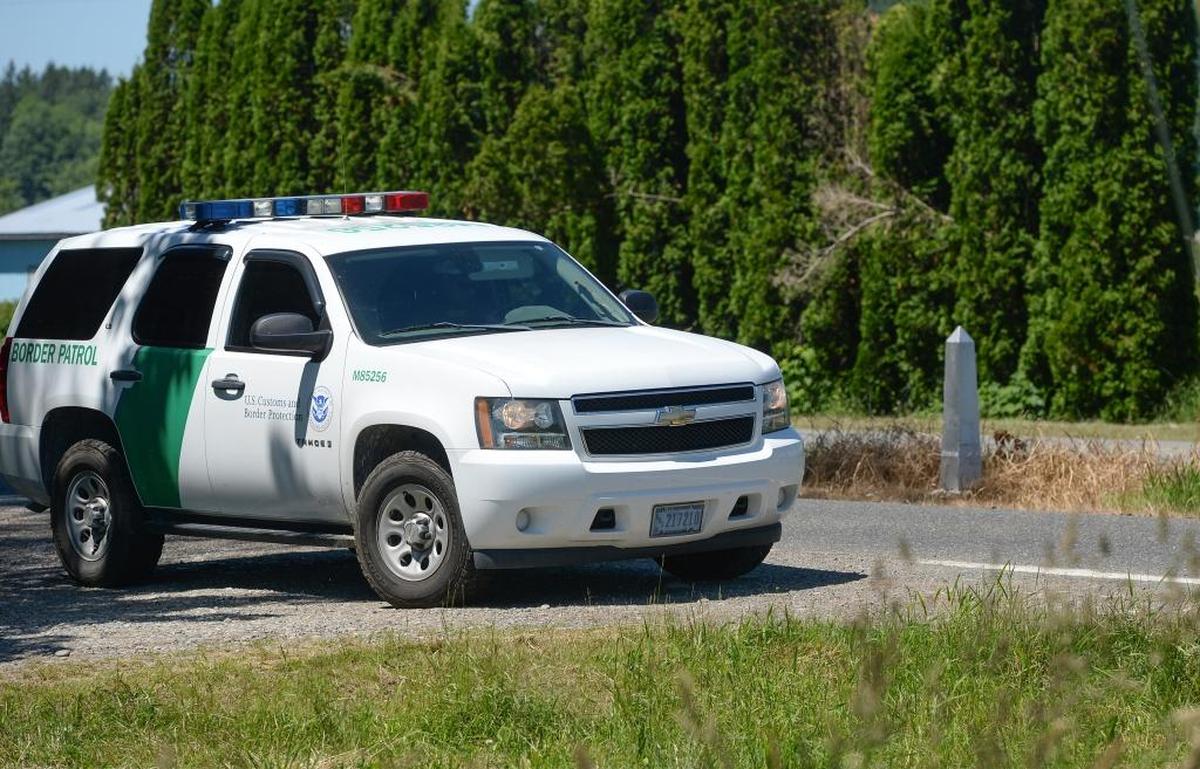 A U.S. Border Patrol vehicle monitors the U.S.-Canada border on East Boundary Road north of Lynden, Washington on Thursday, June 22, 2017. The two countries are separated by the ditch marked with the obelisk between Boundary Road in the U.S. and 0 Avenue in Canada.