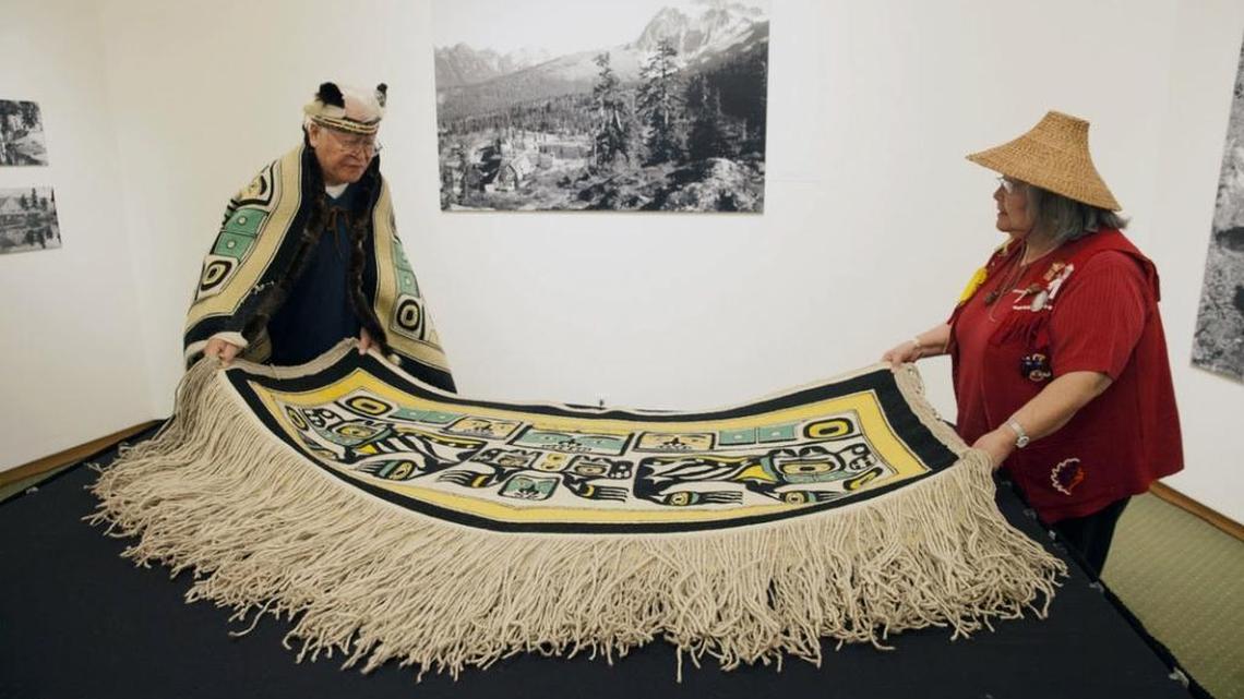 George Samuel and Laverne Wise roll a Tlingit Chilkat blanket in preparation for its return to the Central Council of the Tlingit and Haida Indian Tribes of Alaska. The blanket, which had been in the Whatcom Museum collection for 40 years, was returned to the tribes in a closed ceremony Feb. 19, 2016, in the Rotunda Room of Old City Hall in Bellingham.