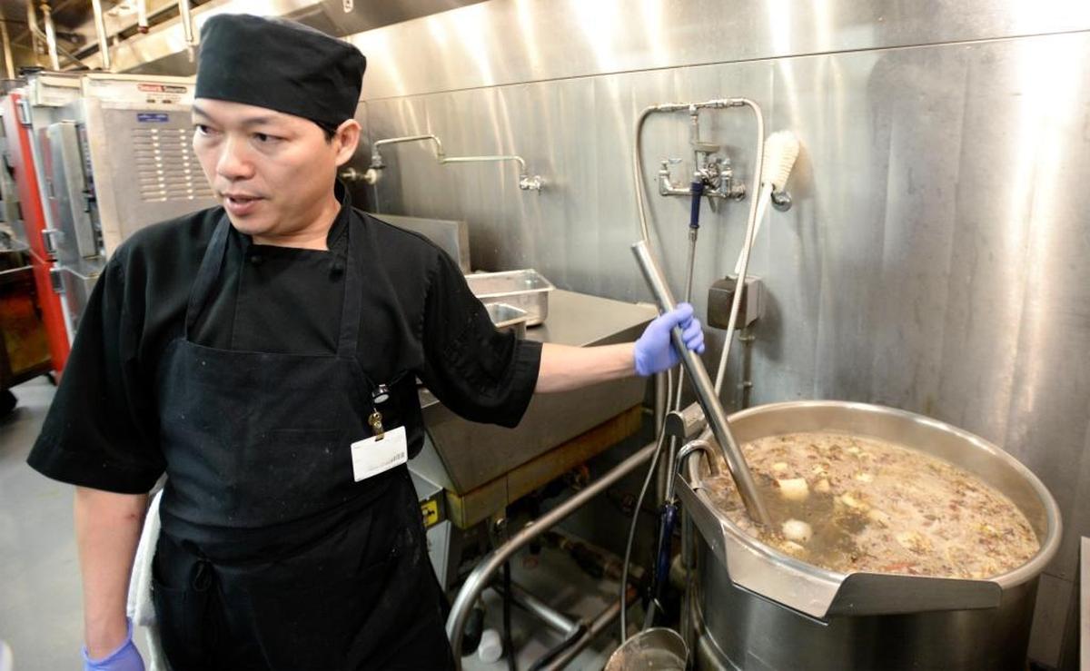 Khanh Trinh cooks the broth for his popular Vietnamese pho on Thursday morning, Jan. 18, 2018, in the kitchen for St. Joseph hospital in Bellingham.