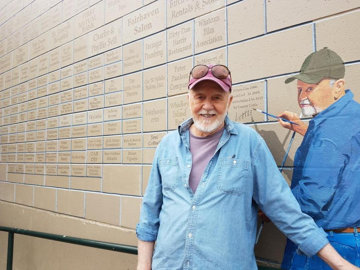 Artist Lanny Little with the painted version of himself in his Fairhaven Village Green mural.