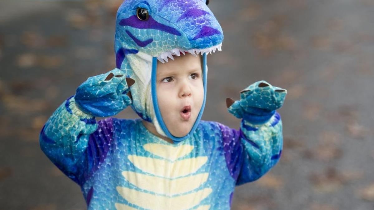 Bentley Greigg, 2, the dinosaur roars at other trick or treaters on Oct. 31, 2014 during the Downtown Bellingham Partnership Trick or Treat.