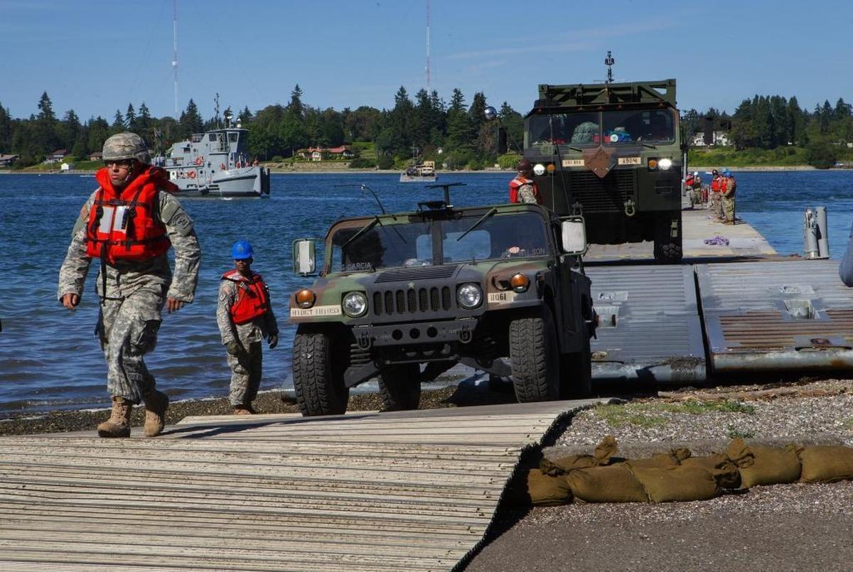 Vehicles and Washington National Guard troops land at Jensen Point on Vashon Island during the Cascadia Rising exercise in June 2016.