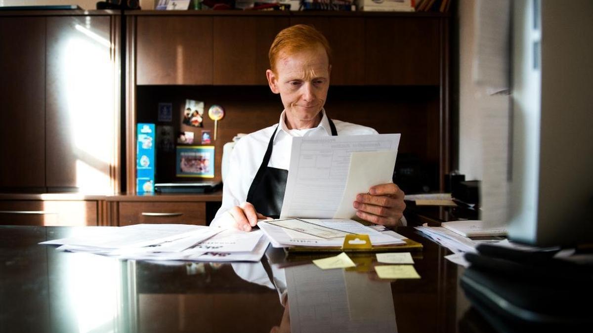 Don White, owner of Skylark's Hidden Cafe in Fairhaven, works at his desk on Wednesday, Dec. 21, 2016, in Bellingham.