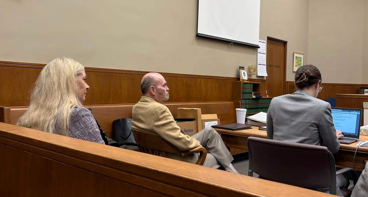 Karen Allen, left, sits behind her husband, Craig Allen, in Whatcom County Superior Court.